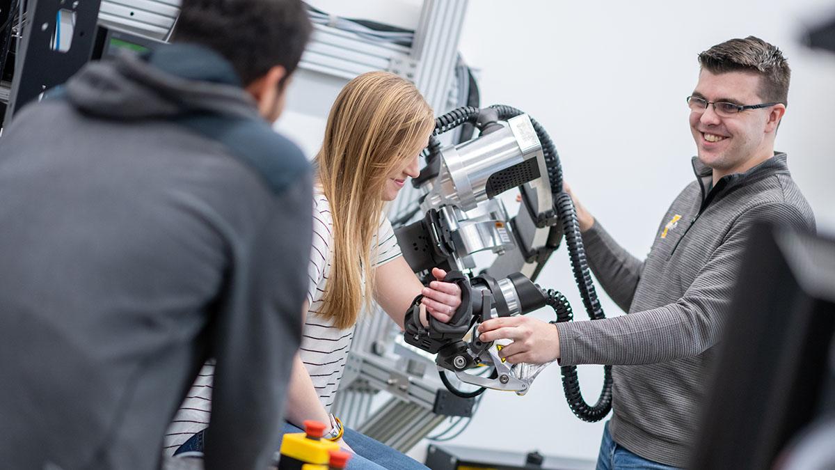 Students work with robotic devices used to develop better therapies for stroke patients.